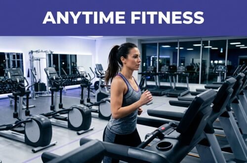 A woman runs on a treadmill inside a modern, well-lit fitness center at night.