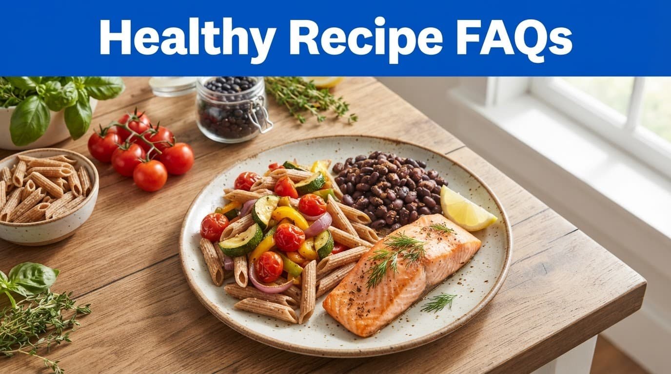 A balanced meal with pasta, vegetables, beans, and fish on a ceramic plate.