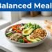 A colorful grain bowl with vegetables, chicken, avocado, and lemon on a bright kitchen counter.
