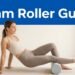 Woman gently rolling her calf on a foam roller in a bright studio.