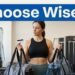 Woman compares two gym bags while holding a gym membership card.