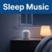 A glowing white speaker on a nightstand in a cozy bedroom beside an amber lamp.