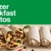 Sliced breakfast burritos and wrapped portions sit on a countertop beneath a green banner.