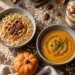 Pumpkin oatmeal, soup, and a yogurt parfait sit on a rustic wooden table.